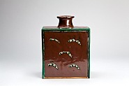 Bottle, kaki glaze with wax resist decoration