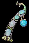 A Highly Important Guild of Handicraft Brooch In the form of a Peacock Standing on an opal orb, it's tail recumbent