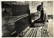 Man Weaving At Loom