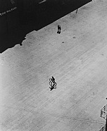Boy on Bike Below Brooklyn Bridge