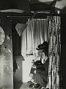 Margaret Bourke-White - Couple posing in photo booth at the 'Dam Mugshot' in town built for construction workers of the Grand Coulee Dam, Grand Coulee, WA., 1937